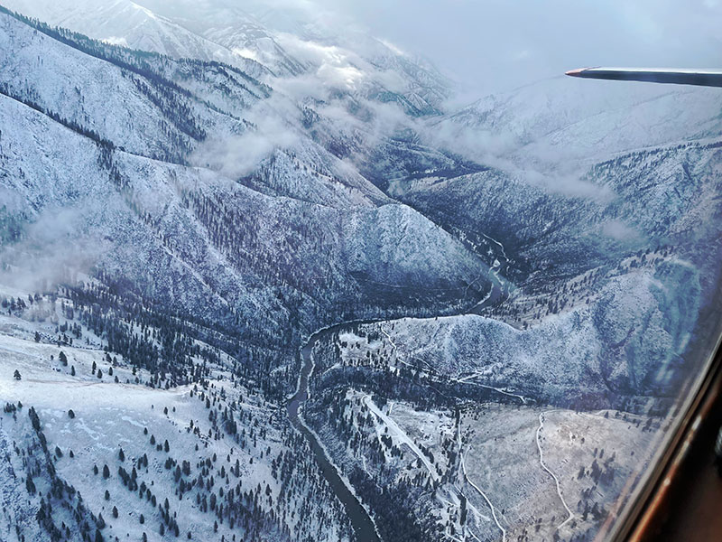 7-Looking-up-the-South-Fork-of-the-Salmon-River-the-McClain-Ranch-airstrip-is-visible-in-the-lower-center-of-photograph.-RH-Holm-Jr.-Photo