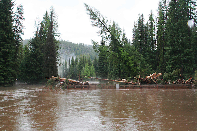Dislodged-bridge-and-debris-heading-away-westward-from-burning-cabin