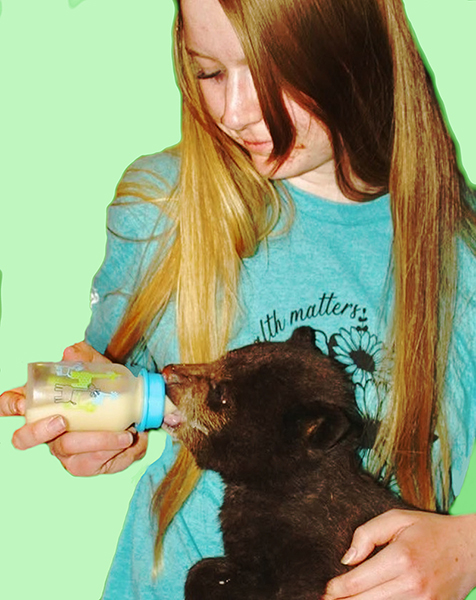 Manager-Genevieve-feeding-a-2-month-old-4-pound-bear-cub