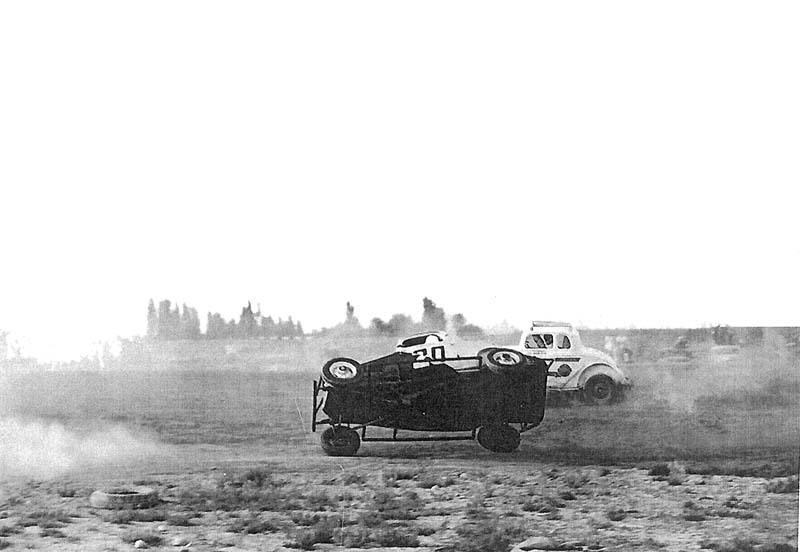 A racer finds himself on two wheels during a race.