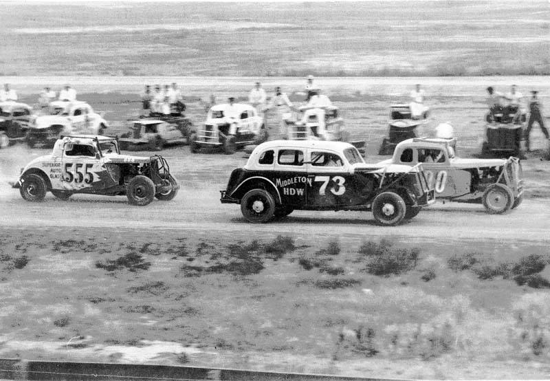 Racers in the pit looks on during a race.