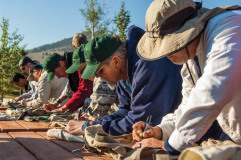 Participants of the Reel Recovery trip sign each other\'s fishing vests
