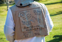 Participants of the Reel Recovery trip sign each other\'s fishing vests