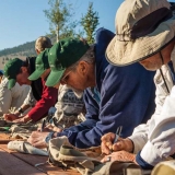 Participants of the Reel Recovery trip sign each other\'s fishing vests