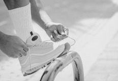 Sporty man tying his shoelaces